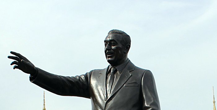 An Image of the Walt Disney Partners Statue with the Retlaw Enterprises, Inc Logo