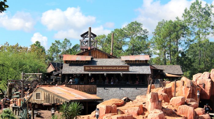 A Photo of The Big Thunder Mountain Railroad Sign and Logo That is Mounted on the Top of the Building